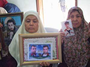 Mothers in Gaza show pictures of their<br>imprisoned sons. 