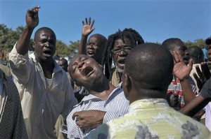 Haitians protest outside courthouse.
