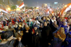 Protesters in Tahrir Square shout slogans against President Mohammed Morsi as they watch his speech. Cairo, Egypt, June 26.