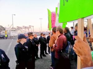 Truckers and community supporters picket the port.