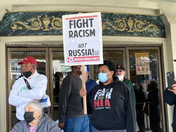 A protester holding a placard saying U.S. war machine: real threat to  peace at a rally against war with Russia sponsored by multiple groups  including CODEPINK: Women for Peace, Black Alliance for