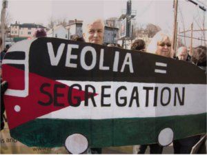A Palestinan flag on a school bus is a symbol of the Bus Drivers Union solidarity with Palestine. When Veolia Corporation attacked their union, the bus drivers publicized Veolia’s role in illegal Israeli settlements in the West Bank.