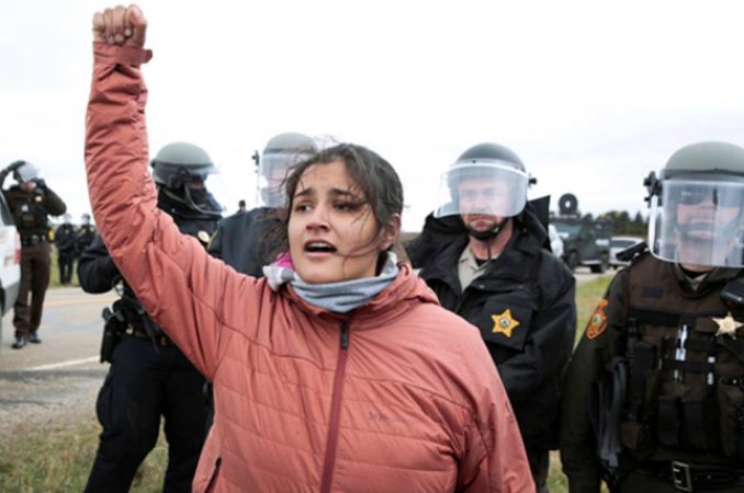 Ta'Sina Sapa Win of South Dakota's Cheyenne River Reservation chants in front of police during a protest against the Dakota Access Pipeline outside Saint Anthony, North Dakota, October 5, 2016. 