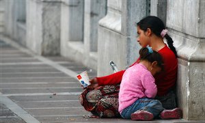A woman begs with her child in Athens, Greece. Some 70 percent of Greek children live in jobless households.