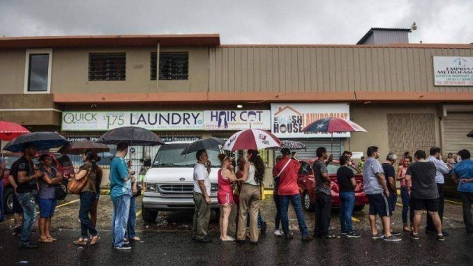 People wait in line to buy ice during the massive blackout in San Juan, Puerto Rico.