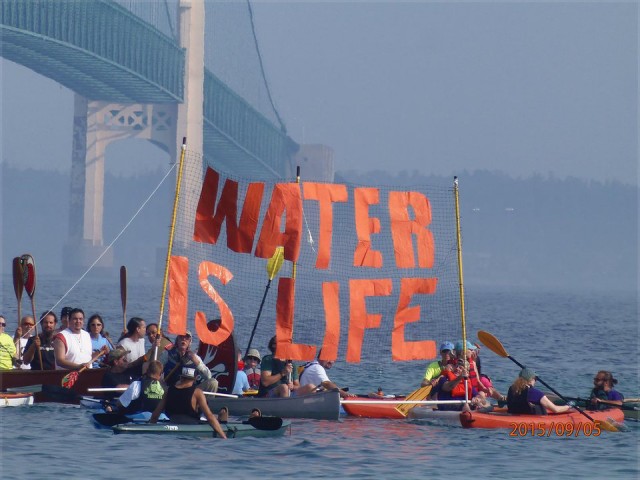  Flotilla protesters set out under the Mackinac Bridge, Sept. 6.Photo: Nancy Haun.