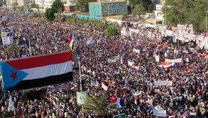 The flag of former South Yemen is seen attached to a billboard during a rally in Yemen's southern port city of Aden October 14, 2014.